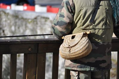 Rear view of man standing on railing