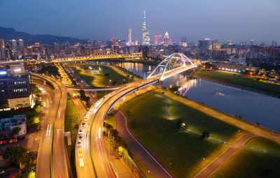 High angle view of illuminated city street and buildings at night