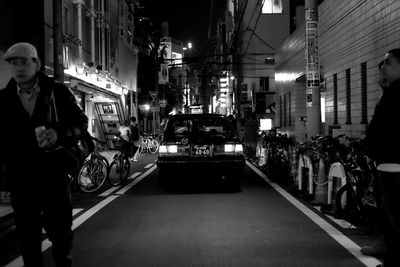 People in illuminated city at night