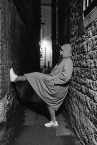 Rear view of woman standing in abandoned house