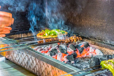 Panoramic shot of meat on barbecue grill