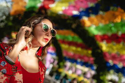 Low angle view of young woman standing in ornamental garden 