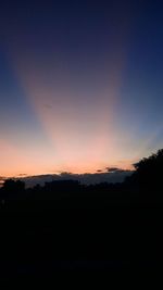 Silhouette landscape against sky during sunset