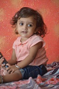 Portrait of cute girl sitting outdoors