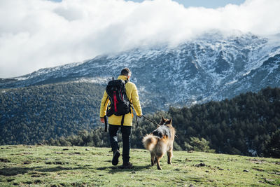 Dog on snowcapped mountains during winter