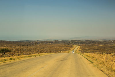 Road amidst landscape against clear sky