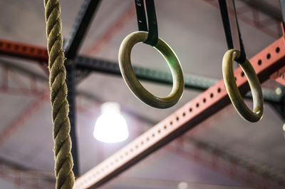 Low angle view of chain hanging on rope