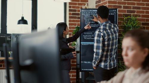 Business colleagues brainstorming on display