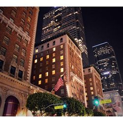 Low angle view of buildings against sky at night