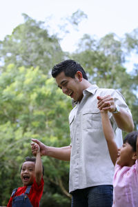 Father and kids at back yard