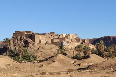 Castle on desert against clear blue sky