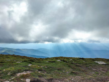 Scenic view of landscape against cloudy sky