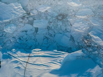 High angle view of ice floating on water