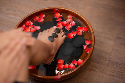 High angle view of hand in container on table