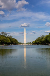 View of monument in city against cloudy sky