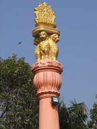 Low angle view of statue against blue sky