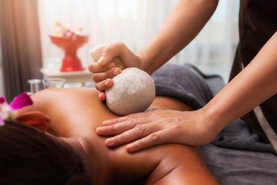 Cropped hands of woman giving medicine