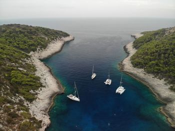High angle view of sailboats on sea shore against sky