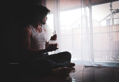 Man having food while sitting at home