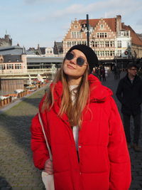 Woman wearing sunglasses standing in city