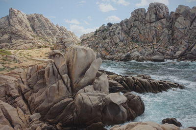 Scenic view of rocks in sea against sky