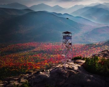 Scenic view of building and mountains against sky