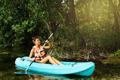 Portrait of woman sitting in hammock