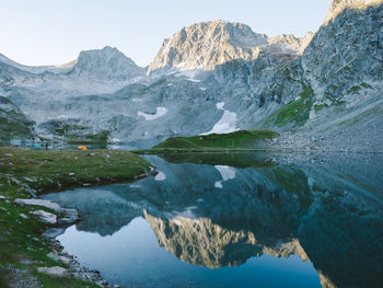 Scenic view of lake and mountains against clear sky