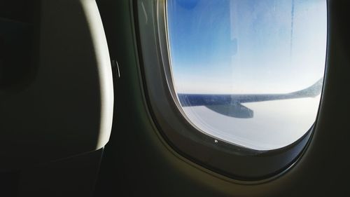 Close-up of car window against sky