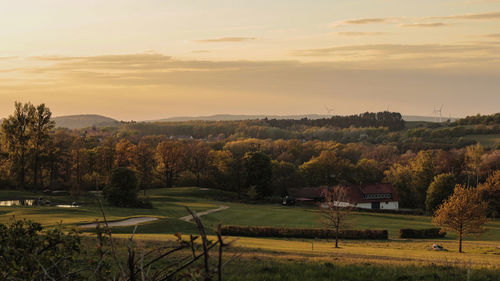 Scenic view of field against sky during sunset