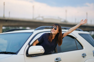 Young woman wearing sunglasses in car