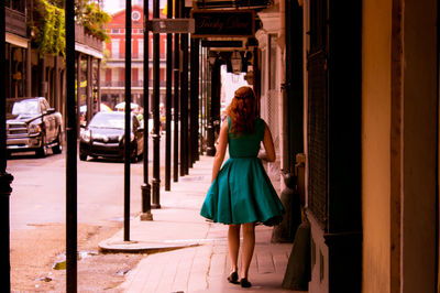 Woman walking along pavement