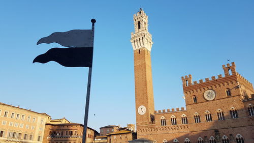 Low angle view of historic building against clear blue sky