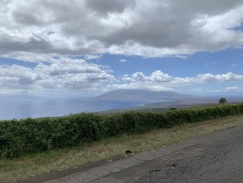 Scenic view of road by land against sky