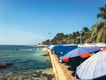 Scenic view of beach against clear blue sky