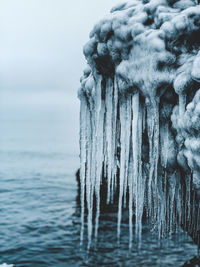 Frozen sea against sky during winter