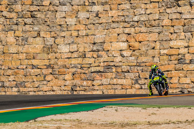 Man working on brick wall