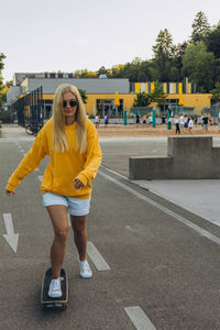 Portrait of young woman walking on road