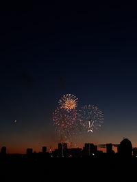 Firework display over city at night