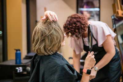 Rear view of friends standing at home