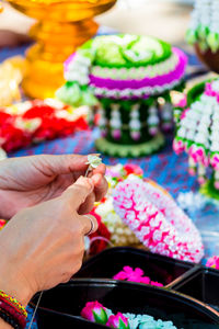 Midsection of woman holding multi colored candies