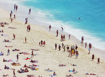 High angle view of people at beach during sunny day