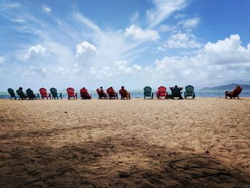 People on beach against sky