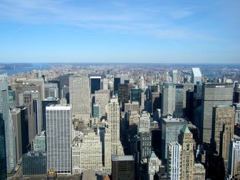 Aerial view of buildings in city against sky