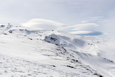 Scenic view of snow covered landscape against sky