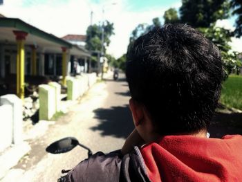 Rear view of man on motorcycle