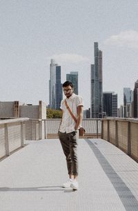 Full length of man standing on building in city