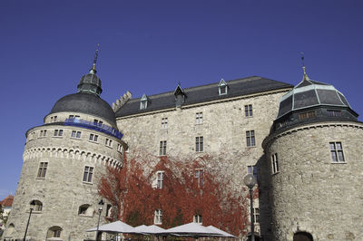 Low angle view of old building against blue sky