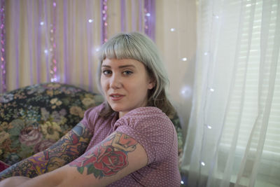 Portrait of young woman sitting indoors