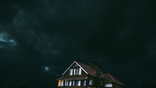 Low angle view of house against sky at night